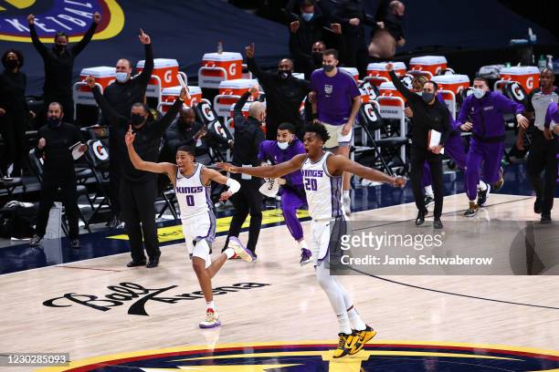 Hassan Whiteside and Tyrese Haliburton of the Sacramento Kings celebrate their last second victory over the Denver Nuggets at Ball Arena on December...