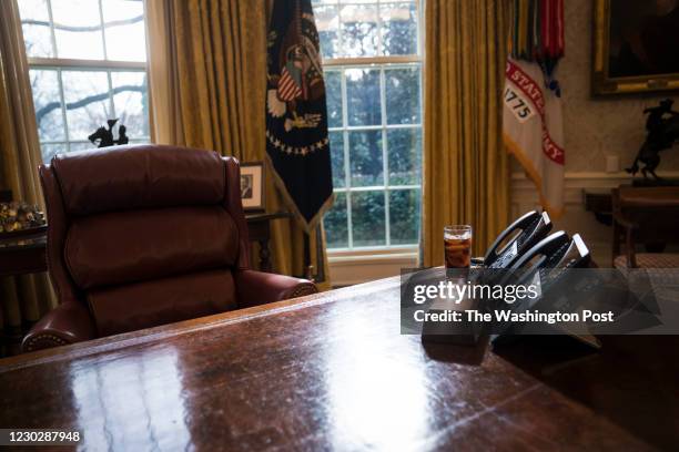 Glass of iced soda is seen on the Resolute Desk as President Donald Trump speaks during a meeting about the opportunity zones provided by tax reform...