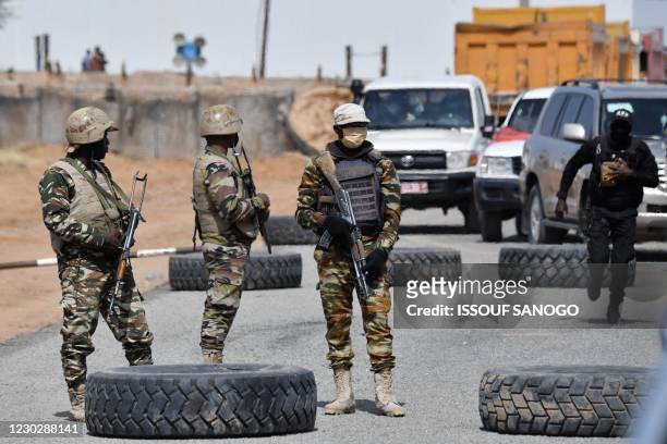 Nigerien soldiers stand guard outside the Diffa airport in South-East Niger, near the Nigerian border, on December 23, 2020. - Under the constant...