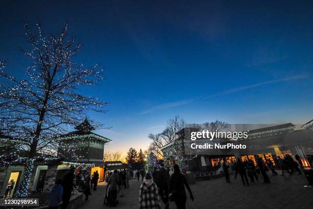 Visitors explore and view the lights on display during the annual PNC Festival of Lights Christmas Celebration at the Cincinnati Zoo and Botanical...