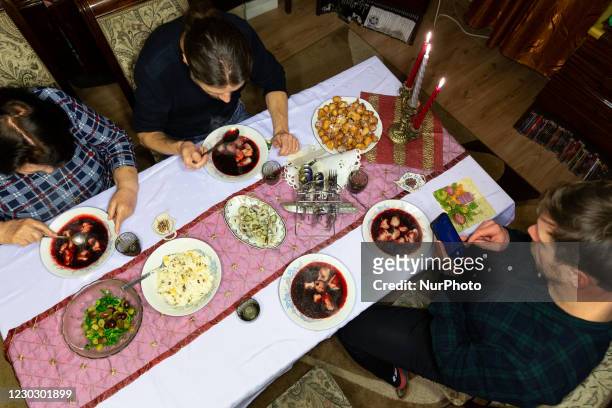 Members of a family celebrate Christmas Eve dinner in very limited numbers amid Coronavirus partial lockdown on December 24, 2020 in a provincial...