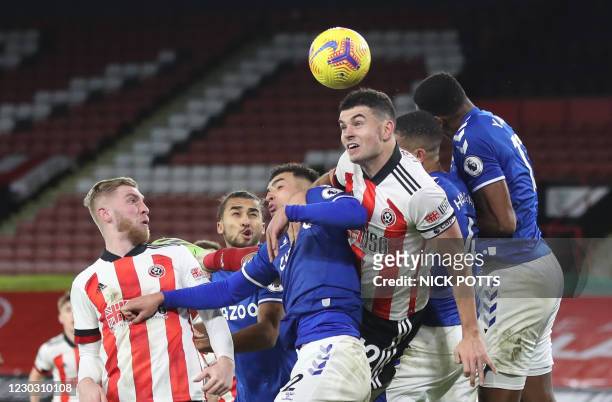 Everton's English midfielder Ben Godfrey and Everton's Colombian defender Yerry Mina for a for a header with Sheffield United's Irish defender John...