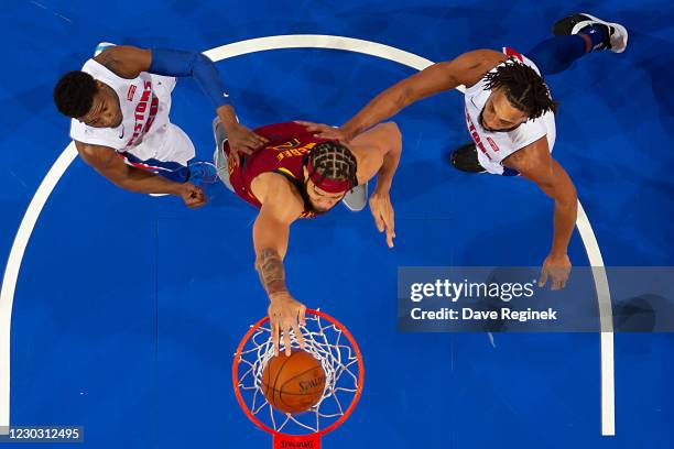 JaVale McGee of the Cleveland Cavaliers drives to the basket for a dunk between Josh Jackson and Jahlil Okafor of the Detroit Pistons in the in the...