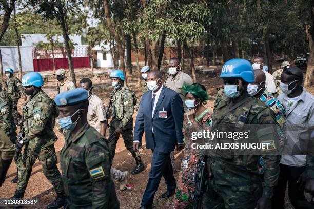 Central African Republic President Faustin Archange Touadera arrives to vote surrounded by Rwandan peacekeepers of the United Nations...