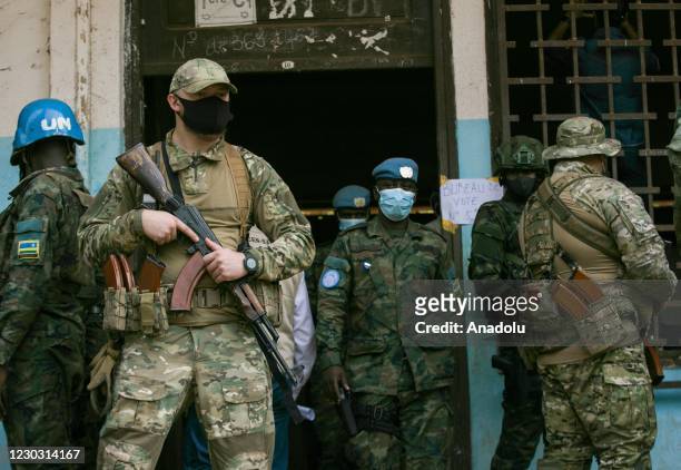 Russian and Rwandan forces take security measures at a polling station during presidential elections in Bangui, Central African Republic on December...