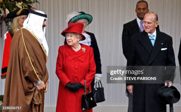 Britain's Queen Elizabeth II , and her husband Prince Philip , greet Qatar's emir, Sheikh Hamad bin Khalifa al-Thani , during a Ceremonial Welcome at...
