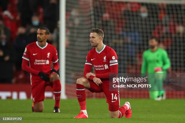 Liverpool's German-born Cameroonian defender Joel Matip (L0 and Liverpool's English midfielder Jordan Henderson 'take a knee' in support of the No...