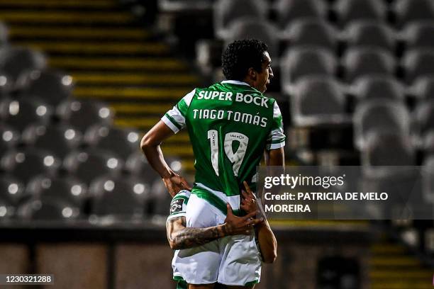 Sporting's Portuguese forward Tiago Tomas celebrates with teammates after scoring a goal during the Portuguese league football match between...