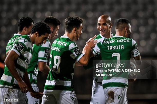 Sporting's Portuguese midfielder Joao Mario celebrates his goal with teammates during the Portuguese league football match between Belenenses SAD and...