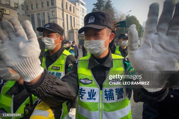 Police attempt to stop journalists from recording footage outside the Shanghai Pudong New District People's Court, where Chinese citizen journalist...