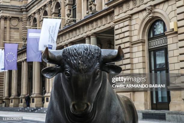 The bull sculpture representing the rise of the market by artist Reinhard Dachlauer is pictured in front of the stock exchange operated by Deutsche...