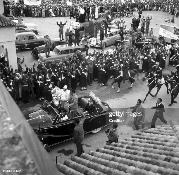 The Sultan of Morocco Mohammed V enters the royal palace, with his son the crown prince Moulay Hassan, welcomed by an enthusiastic crowd, in Rabat on...