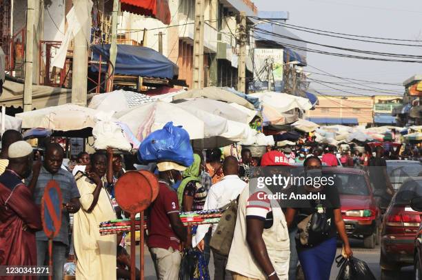 Citizens with some wearing face masks but not keeping social distance, swarm a market area in Lome, Togo on December 29, 2020. Daily life in the...