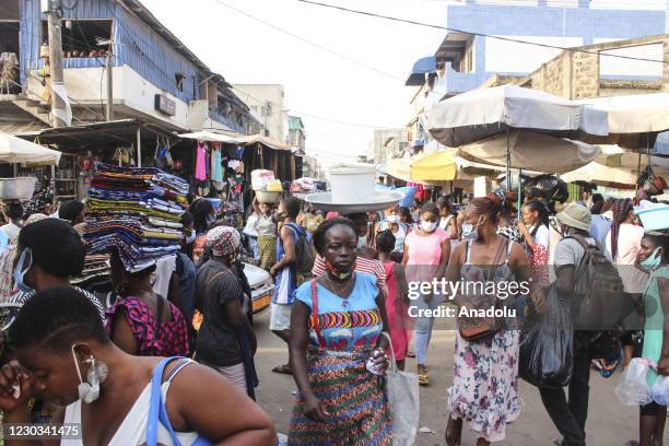 Citizens with some wearing face masks but not keeping social distance, swarm a market area in Lome, Togo on December 29, 2020. Daily life in the...