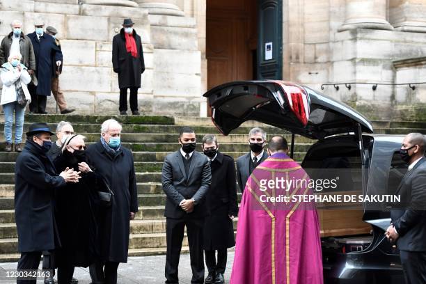 The priest and Michele Cambon-Brasseur and Alexandre Brasseur , respectively widow and son of late French actor Claude Brasseur, pay a last tribute...