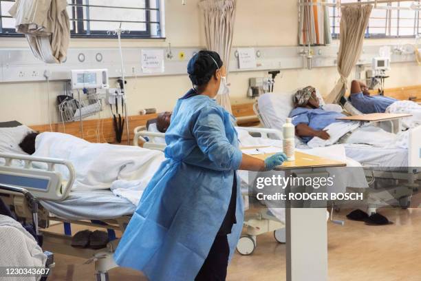 Hospital worker walks amongst patients with COVID-19 in the COVID-19 ward at Khayelitsha Hospital, about 35km from the centre of Cape Town, on...