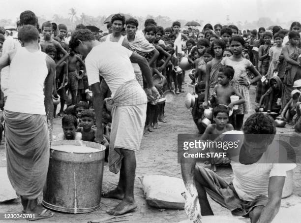 Refugees from East Pakistan wait on August 9 during the distribution of rice and lentils by an Indian organization. Since the attempted secession,...