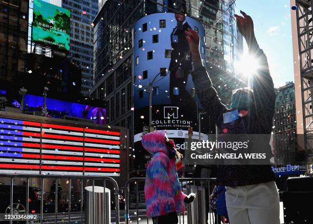 People play with confetti as New Year's Eve organizers test the air worthiness of confetti from the Hard Rock Cafe Marquee in Times Square on...