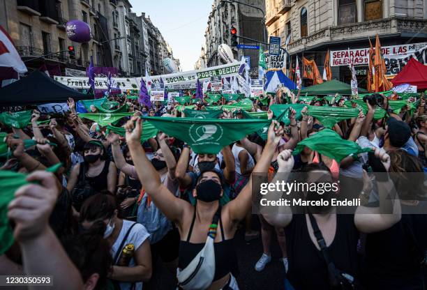 Pro-choice demonstrator raise green kerchiefs outside the National Congress as senators decide on legalization of abortion on December 29, 2020 in...