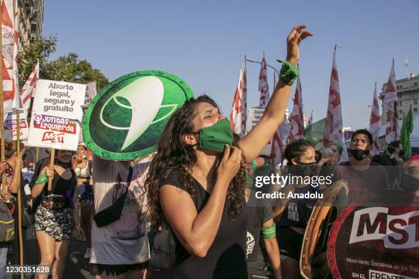 Pro-choice demonstrations, wearing green things, gather outside the National Congress as senators decide on legalization of abortion, in Buenos...