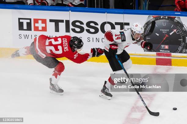 Dylan Cozens of Canada skates against Lorenzo Canonica of Switzerland during the 2021 IIHF World Junior Championship at Rogers Place on December 29,...