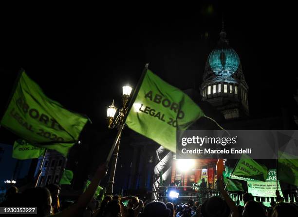 Pro-choice demonstrators wave flags outside the National Congress as senators decide on legalization of abortion on December 29, 2020 in Buenos...