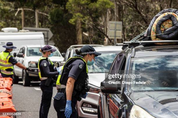 Police officers patrol and check for entry permits to Victoria at a border checkpoint on December 29, 2020 in Mallacoota, Australia. Border...