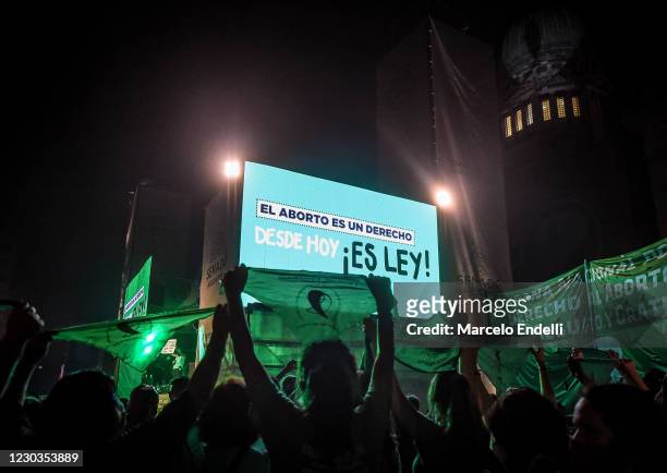 View of a digital sign reading, "El Aborto Es Un Derecho. Desde Hoy, Es Ley!" Pro-choice demonstrators celebrate after the right to an abortion is...