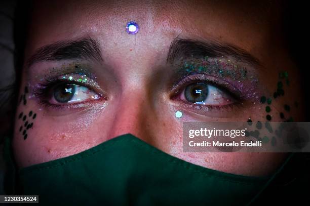 Pro-choice demonstrator, wearing a face mask, waits outside the National Congress as senators decide on legalization of abortion on December 30, 2020...