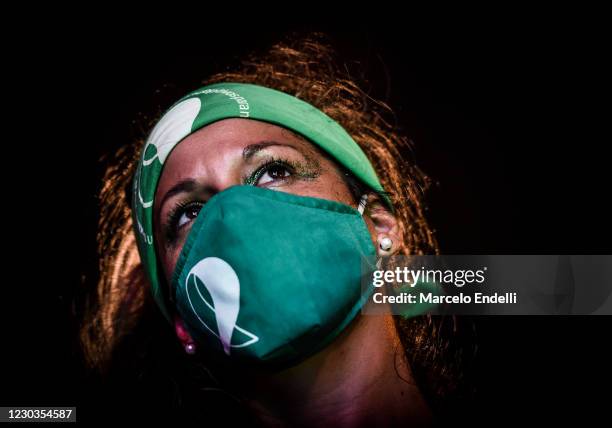 Pro-choice demonstrator, wearing a face mask, waits outside the National Congress as senators decide on legalization of abortion on December 30, 2020...