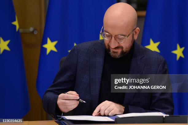 European Council President Charles Michel signs, in Brussels, on December 30 the Brexit trade agreement due to come into force on January 1, 2021. -...