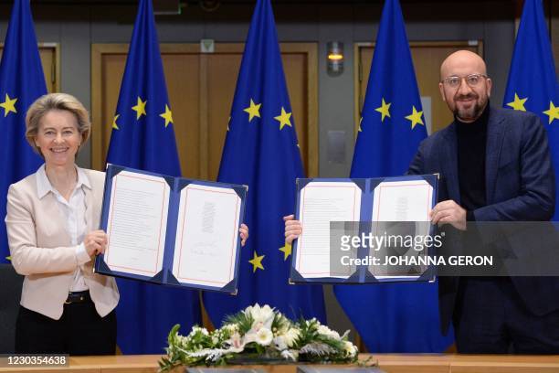 European Commission President Ursula von der Leyen and European Council President Charles Michel pose in Brussels, on December 30, 2020 as they show...