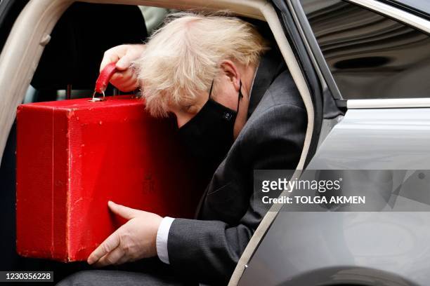 Britain's Prime Minister Boris Johnson arrives back at 10 Downing Street in London on December 30, 2020 after opening the debate on the second...