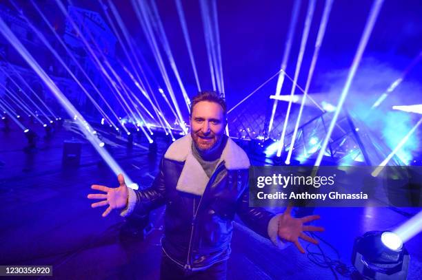 David Guetta poses as he performs his New Year's Eve fundraising streaming event on December 29, 2020 in front of the Louvre’s pyramid in Paris,...