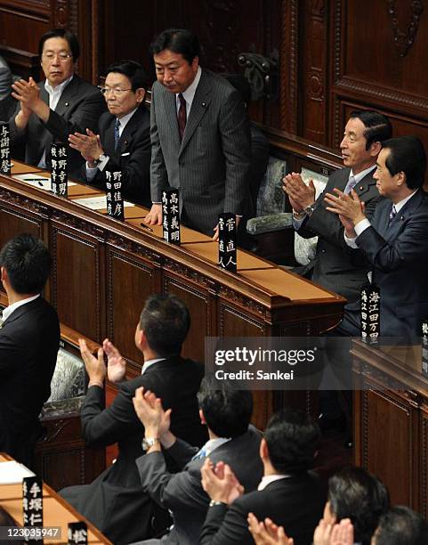 New Democratic Party of Japan President Yoshihiko Noda is applauded by fellow lawmakers after being elected Japan's 95th Prime Minister at the lower...