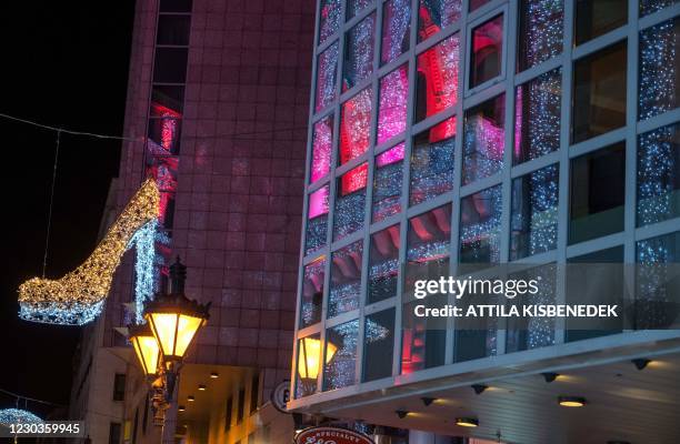 Christmas decoration is seen in an empty shopping street during the curfew in downtown Budapest on December 29 as Hungarians prepare to celebrate the...