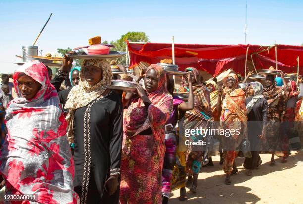 Sudanese women take part in a sit in to protest against the end of the mandate of the United Nations and African Union peacekeeping mission , in...