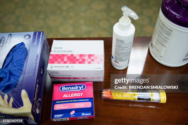 An epinephrine shot and antihistamine are seen are seen in an observation area as the Pfizer COVID-19 vaccine is administered to staff at the Goodwin...