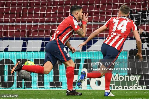 Atletico Madrid's Uruguayan forward Luis Suarez celebrates with Atletico Madrid's Spanish midfielder Marcos Llorente after scoring a goal during the...