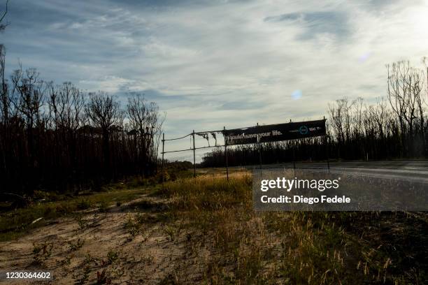 View of a burnt sign on the Princess Highway on December 31, 2020 in Mallacoota, Australia. New Year's Eve marks one year since bushfires swept...
