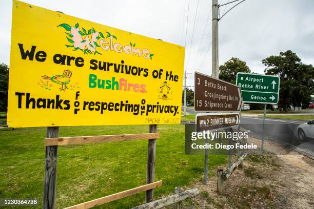 Sign at the entrance of Mallacoota reads "We are Survivors of the Bushfires" on December 31, 2020 in Mallacoota, Australia. New Year's Eve marks one...
