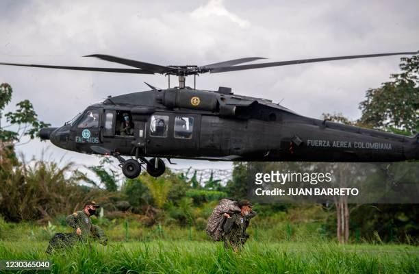 Colombian police officers take part in an operation to eradicate illicit crops in Tumaco, Narino Department, Colombia on December 30, 2020. - The...