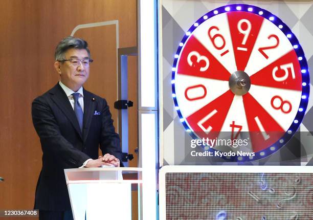 Japanese Internal Affairs and Communications Minister Ryota Takeda attends the year-end Jumbo lottery draw in Tokyo on Dec. 31 with up to 1 billion...