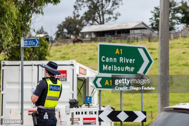 Police officer stands by at the Victoria border checkpoint on December 31, 2020 in Mallacoota, Australia. Border restrictions remain in place between...