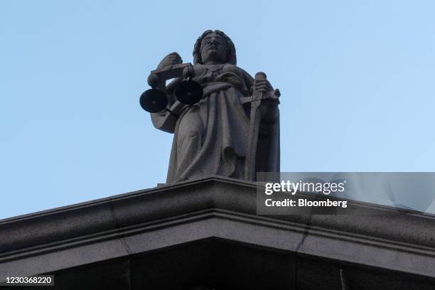 The Lady Justice statue atop the Court of Final Appeal in Hong Kong, China, on Thursday, Dec. 31, 2020. Hong Kong's courts are on the front lines of...