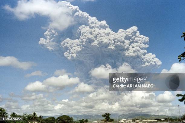 Giant volcanic mushroom cloud explodes some 20 kilometers high from Mount Pinatubo above almost deserted US Clark Air Base, on June 12, 1991 followed...