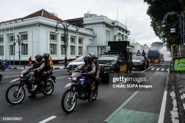 Police officers wearing face masks as a preventive measure against Covid19 patrol the streets in Bandung during the disinfecting activity. Police and...