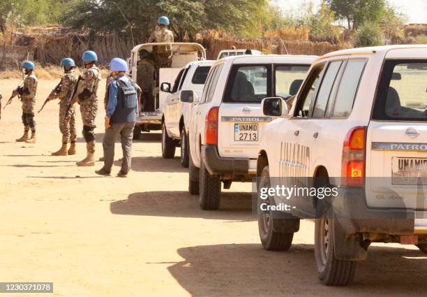 Members of the United Nations and African Union peacekeeping mission gather with their vehicles in Kalma camp for internally displaced people in...