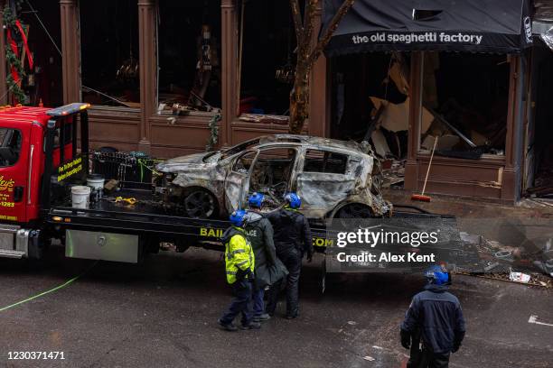 Inspects the inside of an incinerated vehicle before it is towed from Second Avenue on Decemeber 31, 2020 in Nashville, TN. On Christmas morning,...