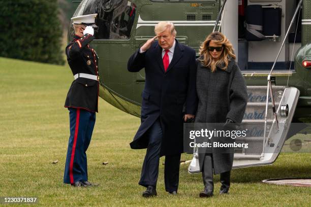 President Donald Trump and First Lady Melania Trump walk on the South Lawn of the White House after arriving on Marine One in Washington, D.C., U.S.,...